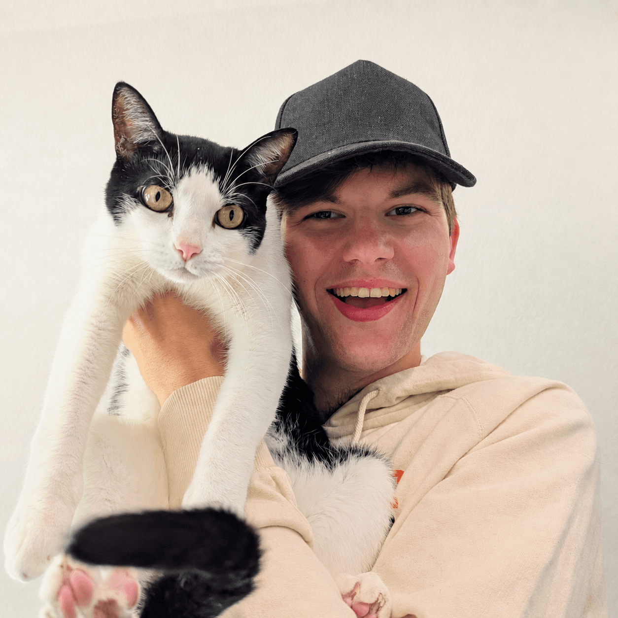 Douglas Young holding a black-and-white cat.